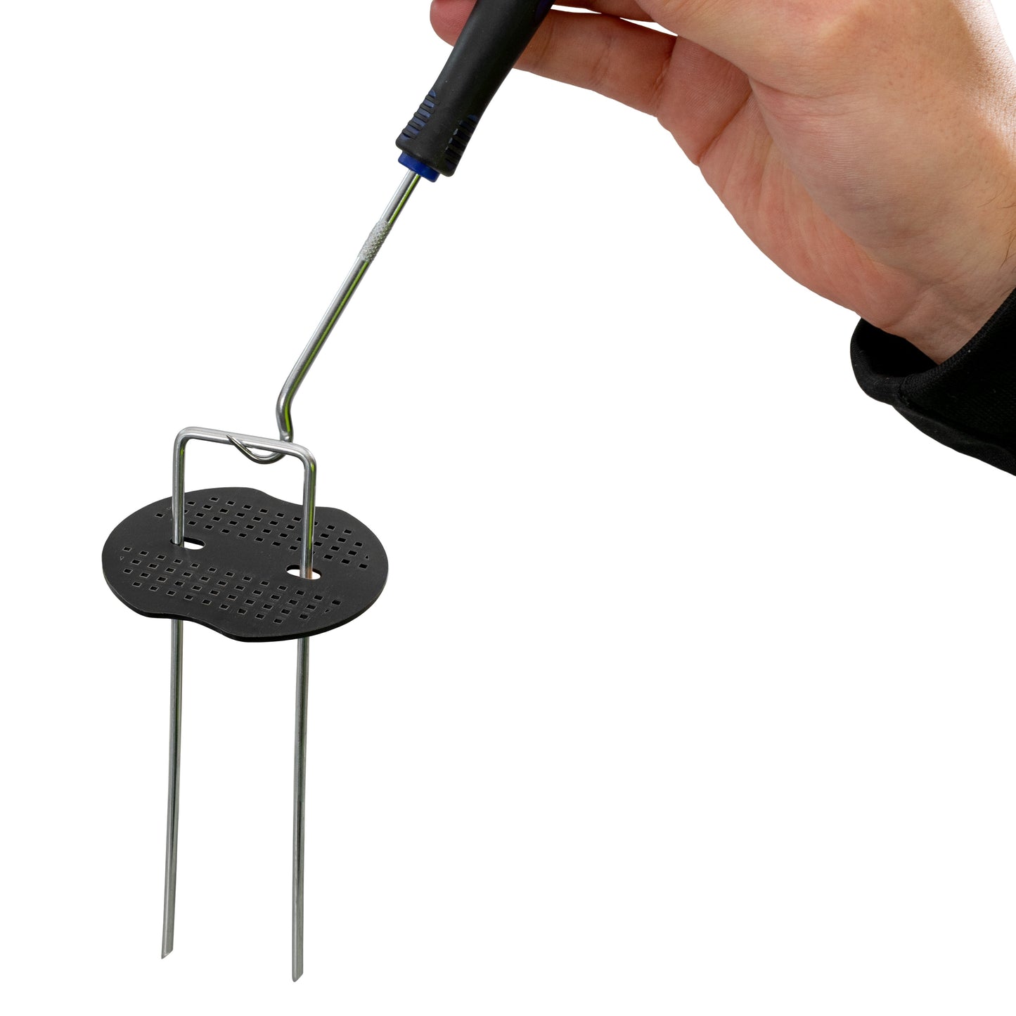 Weed control membrane peg washer being installed: perforated black base on metal pins