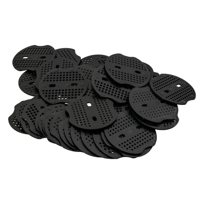 Weed control membrane peg washers—several black perforated base discs, overlapping