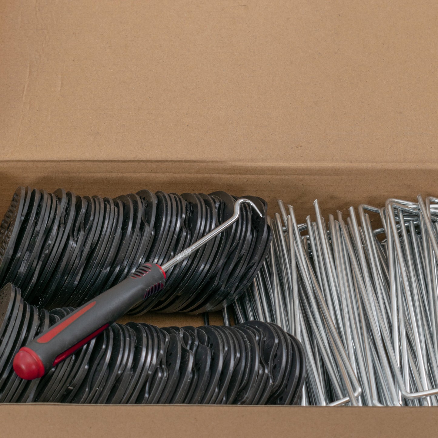 Weed control membrane pegs kit in box: black washer bases with silver metal stakes