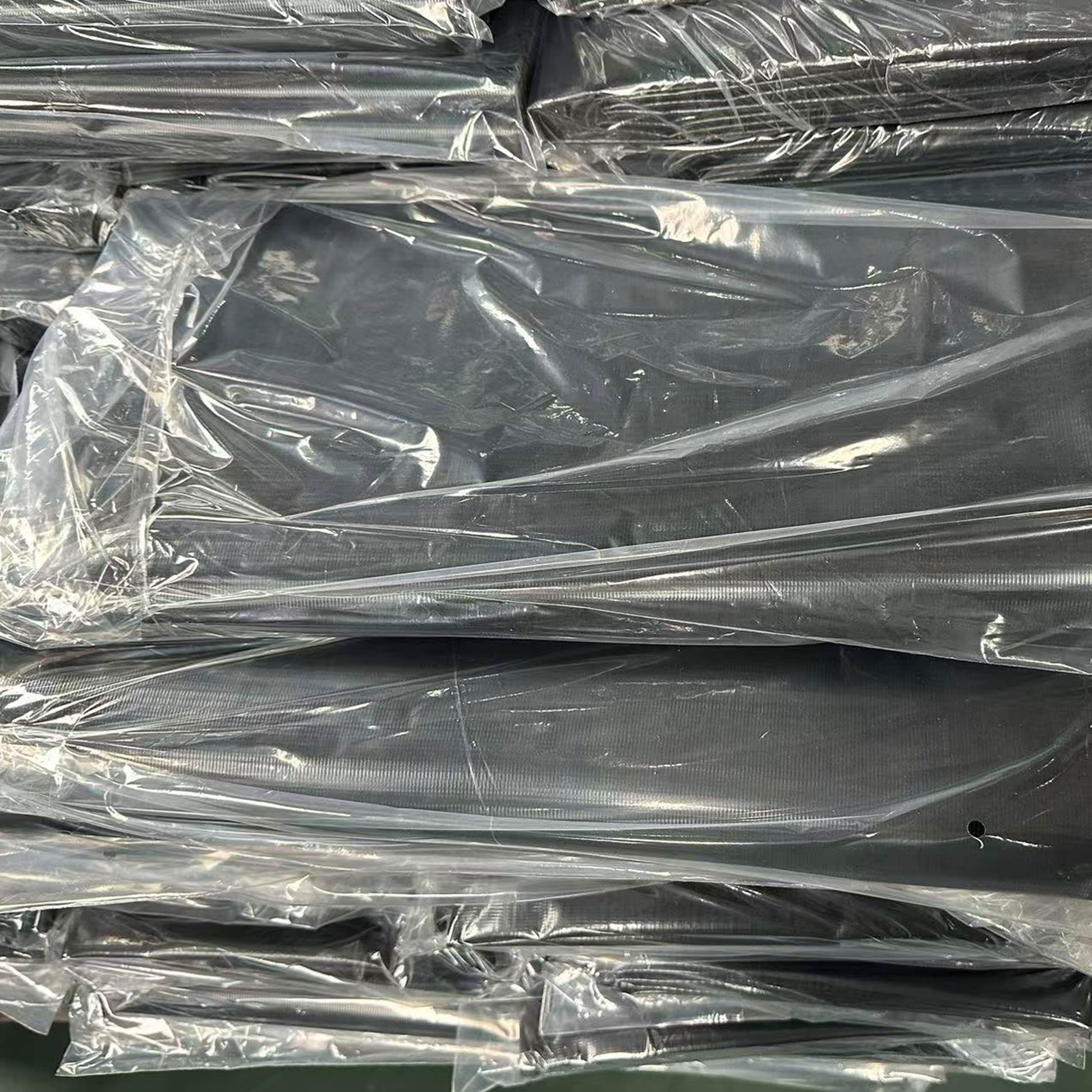 Rolled black PVC pond liner with protective plastic wrap