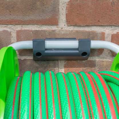 Hose reel wall bracket holding a green hose on the wall