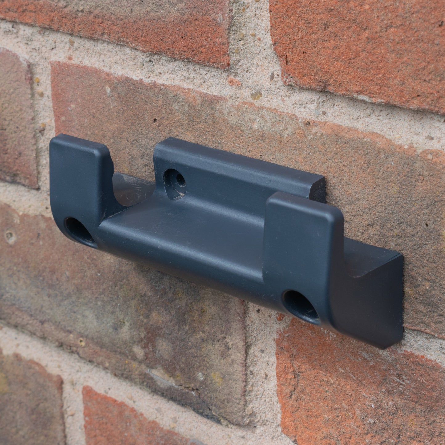 Hose reel wall bracket, dark grey plastic with two mounting holes