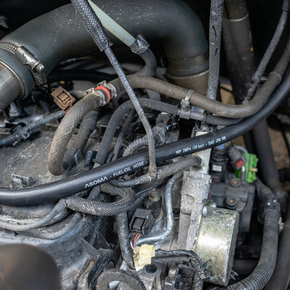 Rubber fuel hose with SAE J30 R6 marking, installed on vehicle
