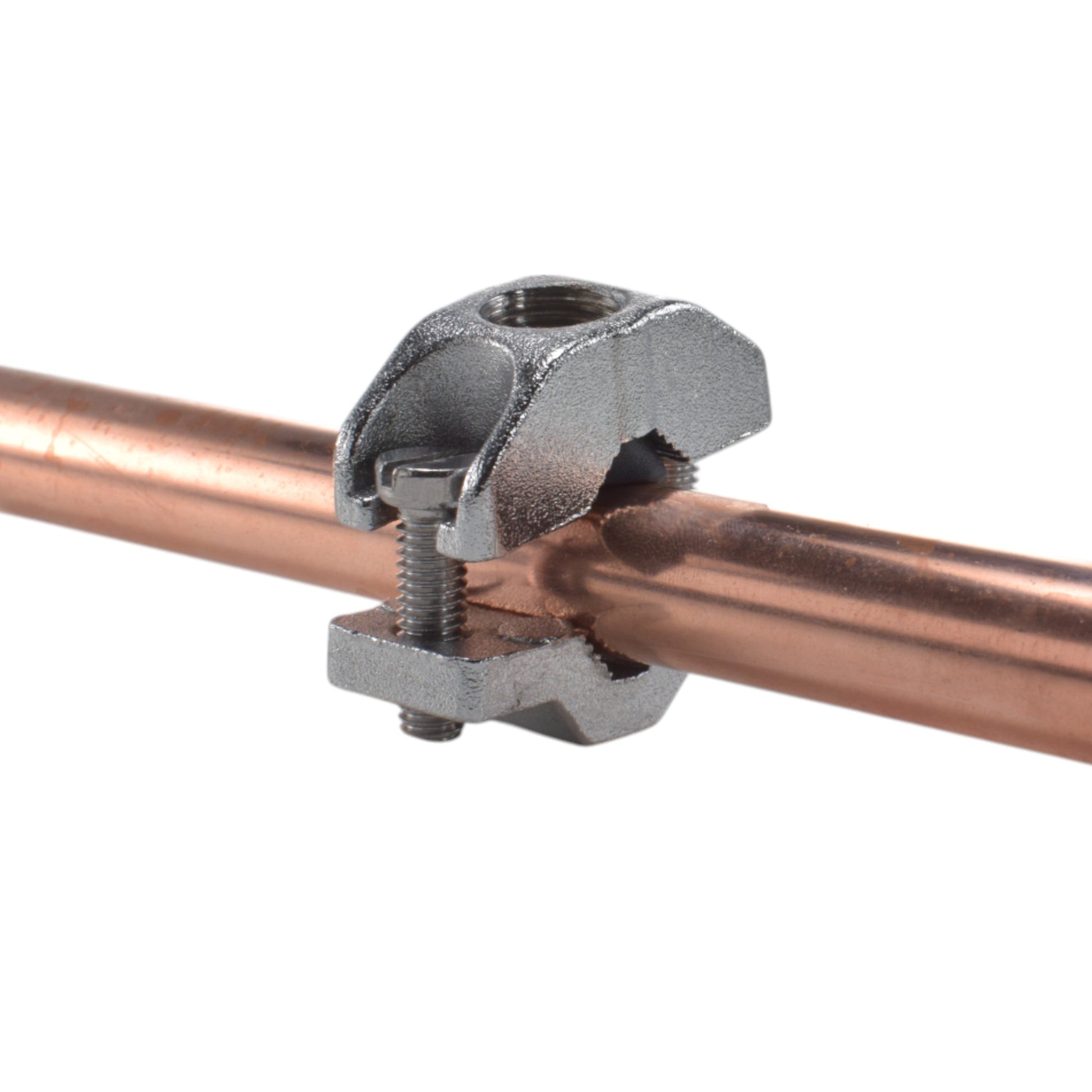 Wall clamp with bolts securing the copper pipe to the valve assembly