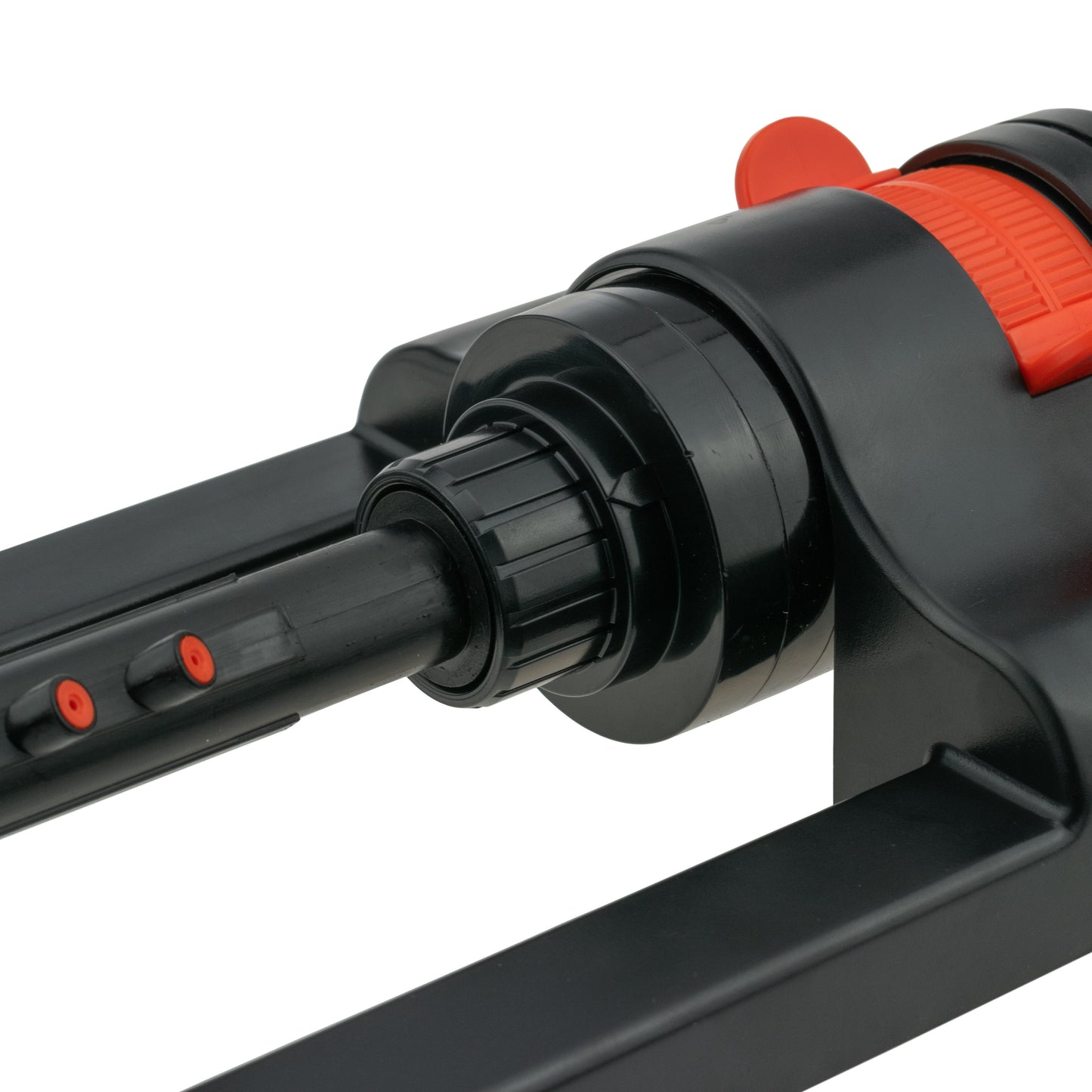 Close-up of black sprinkler head with orange wheel and built-in nozzle fittings
