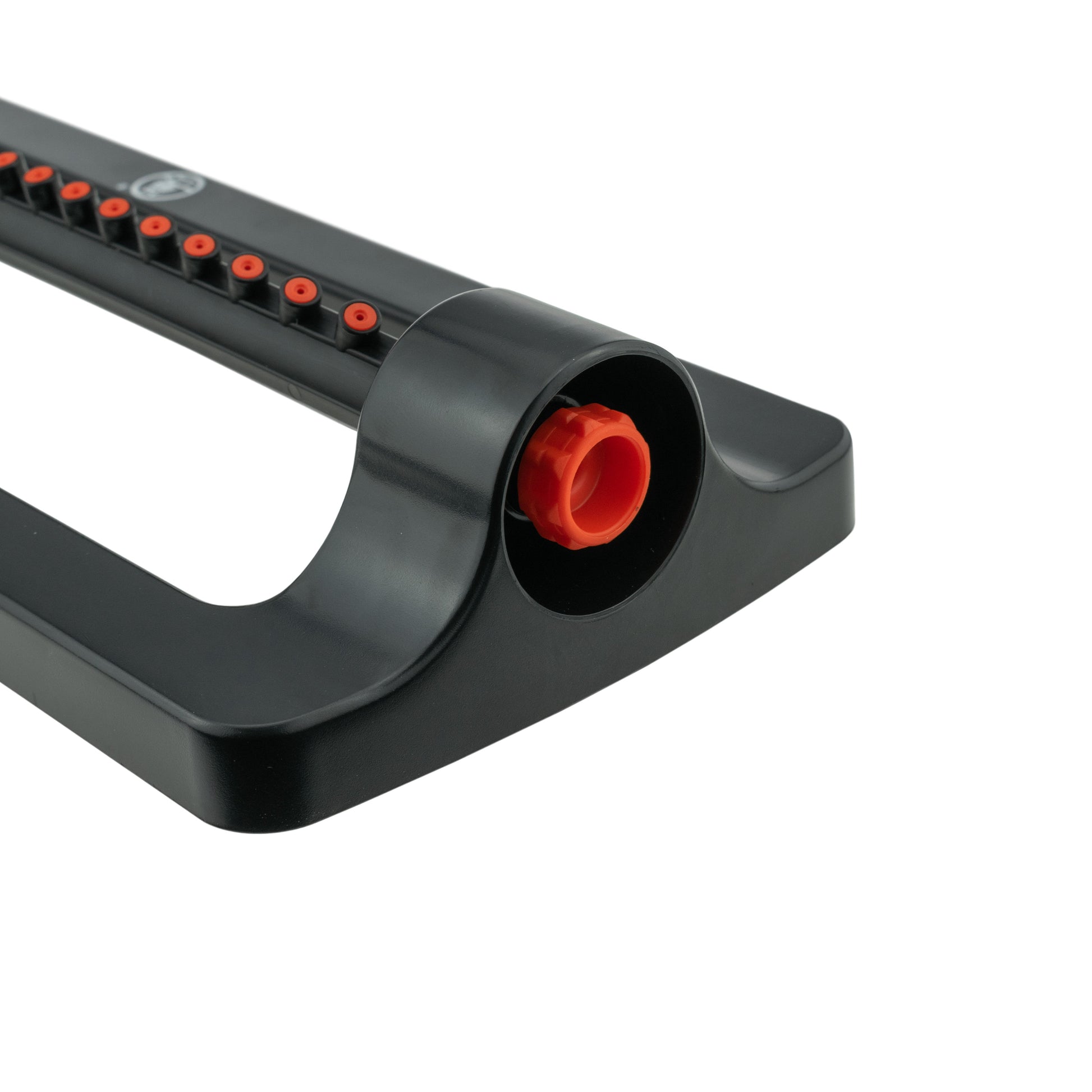 Black sprinkler base end with circular orange inlet plug and visible spray holes