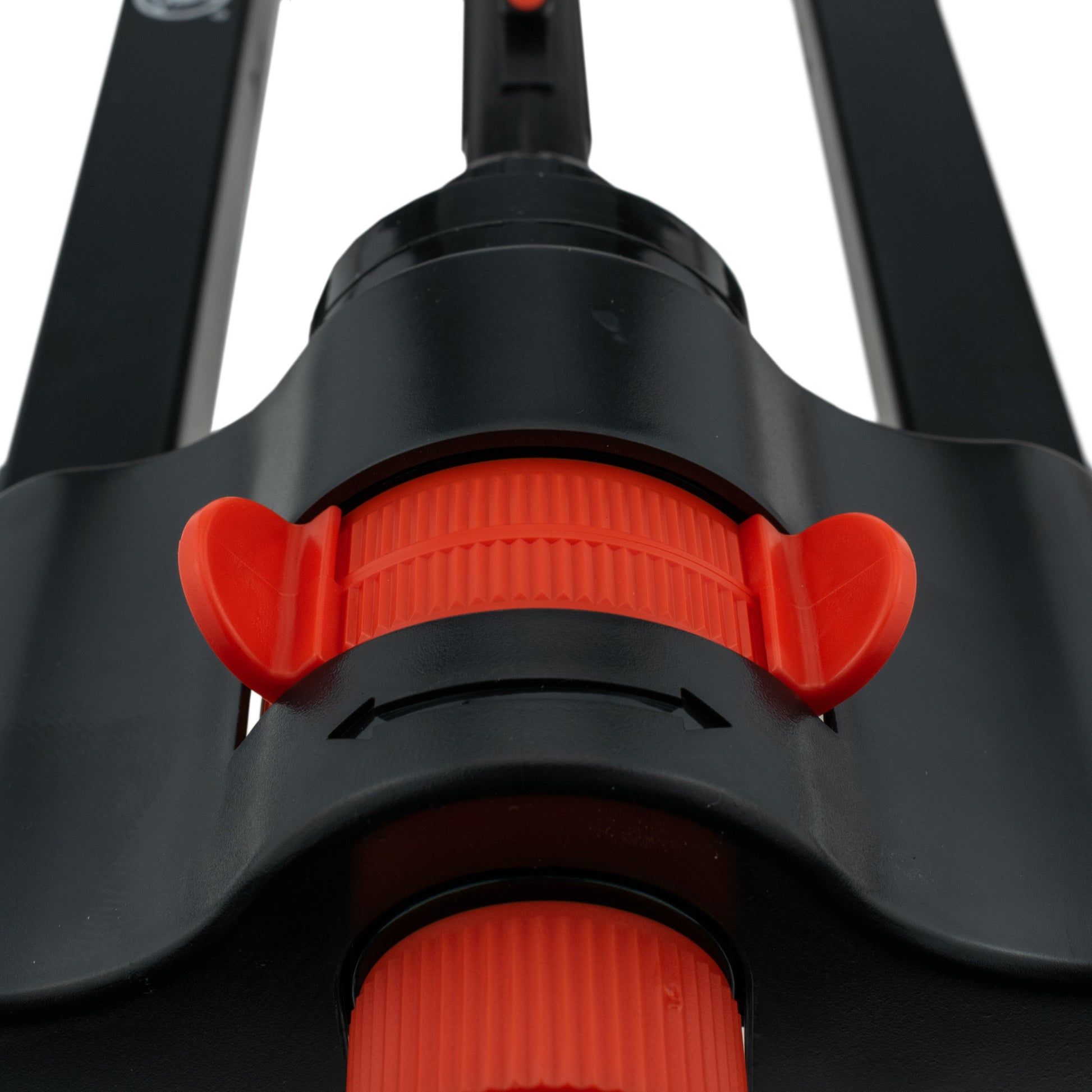 Orange adjustment ring on black sprinkler head with water outlet