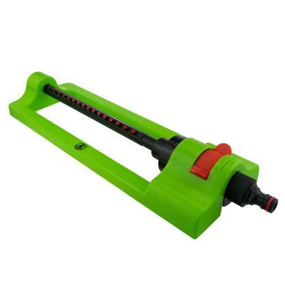 Green oscillating sprinkler on base frame with red control dial and hose connector
