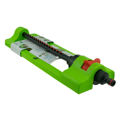 Green oscillating sprinkler with red adjustment dial and hose connector