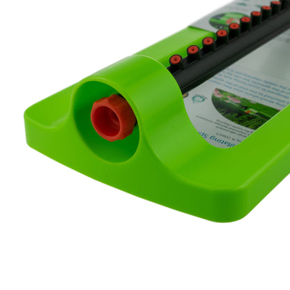 Oscillating sprinkler outlet area: green housing with orange insert and black bar