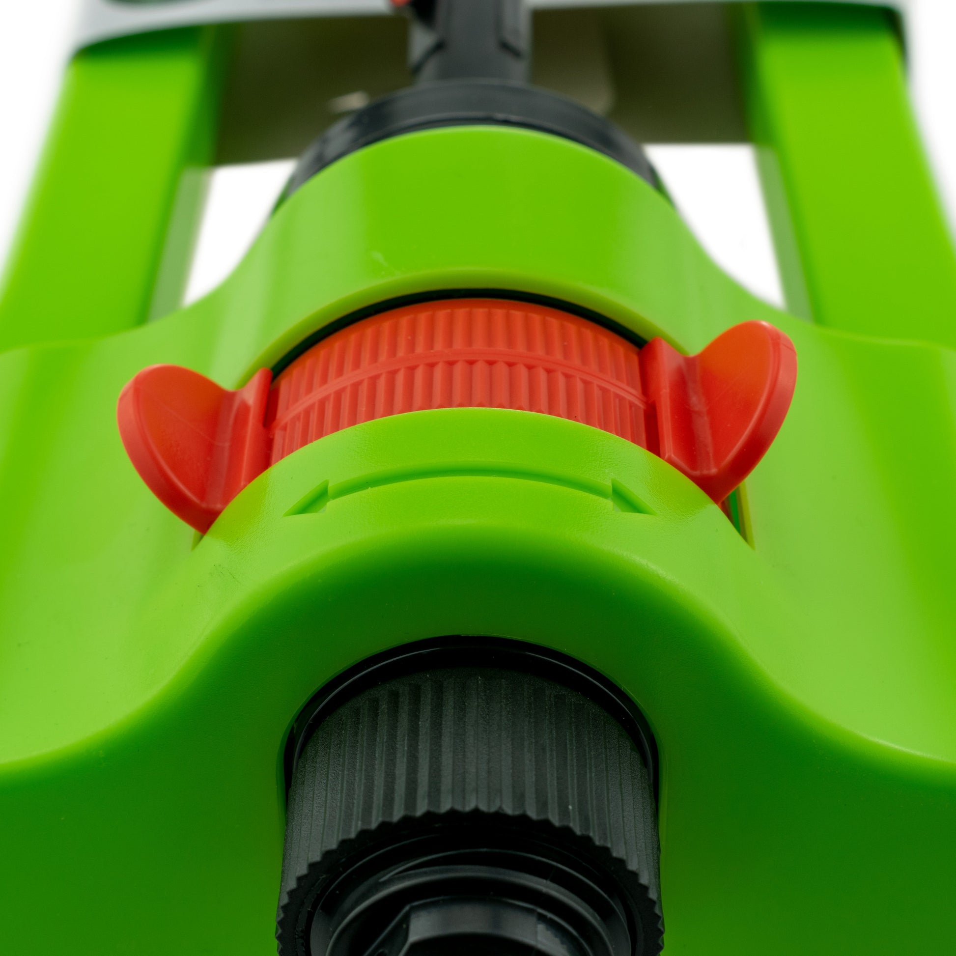 Oscillating sprinkler front close-up: orange gear dial and black connector base
