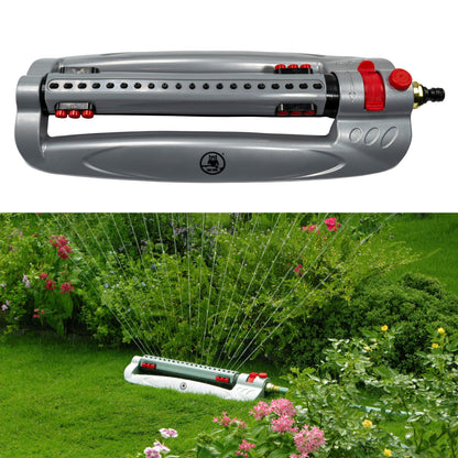 Turbo oscillating sprinkler spraying over grass with gray body and red controls