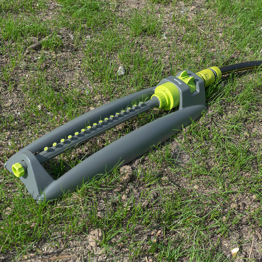 Oscillating bar sprinkler with grey frame and lime-green spray nozzle row