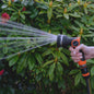Orange-and-black hose water sprayer with wide spray stream from nozzle