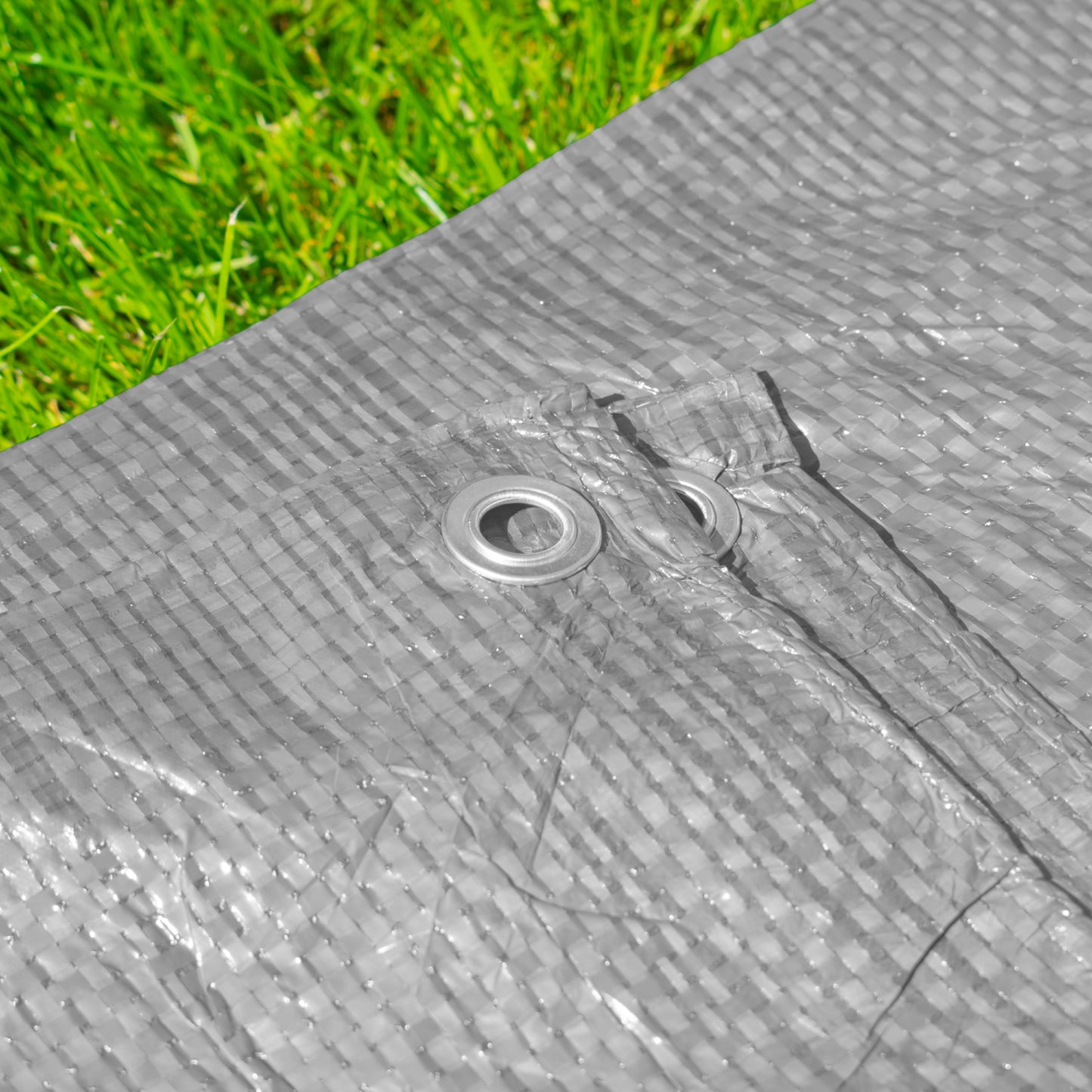 Gray tarpaulin fabric texture with reinforced metal eyelet and corner stitching