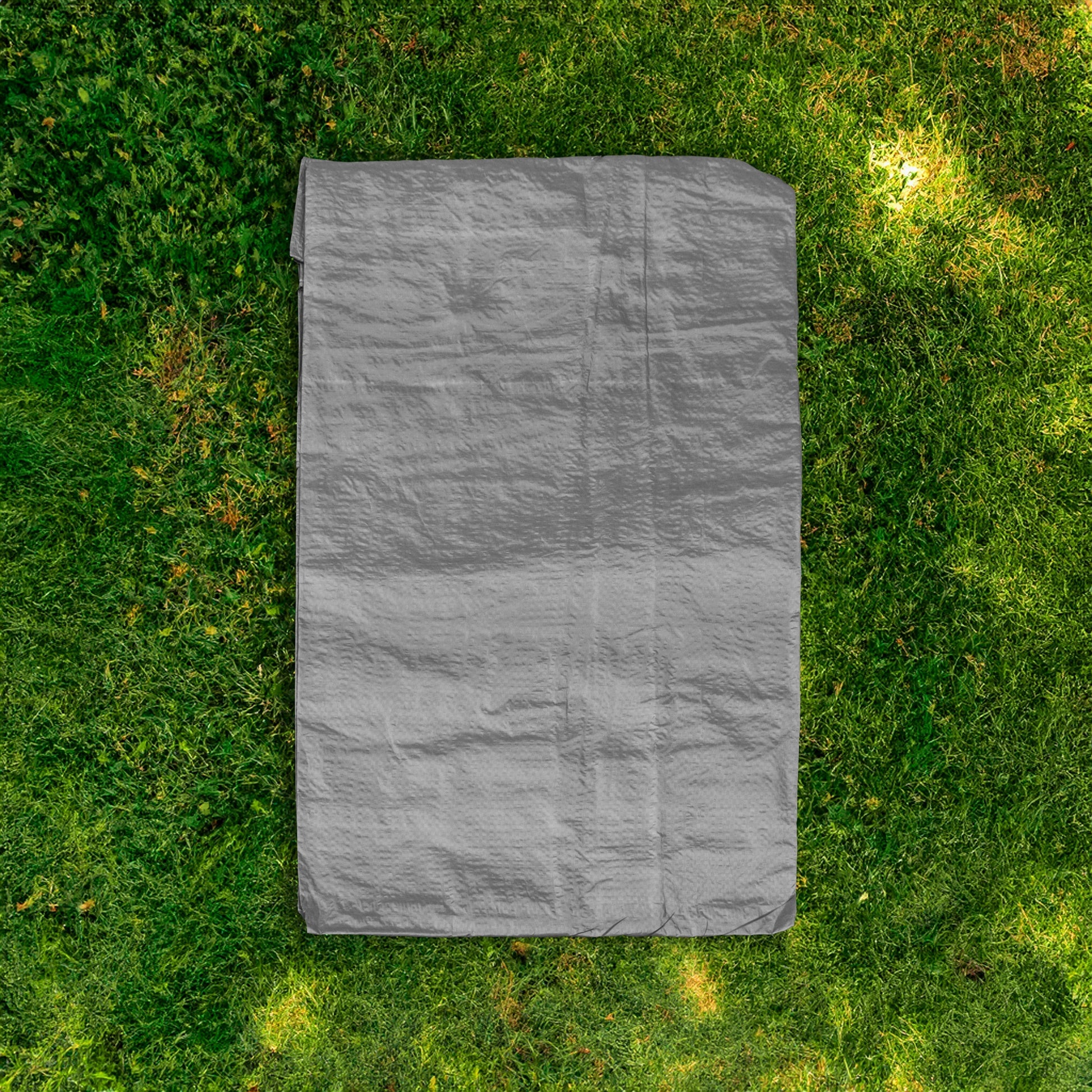 Folded gray tarpaulin, compact rectangle with visible creases and seams