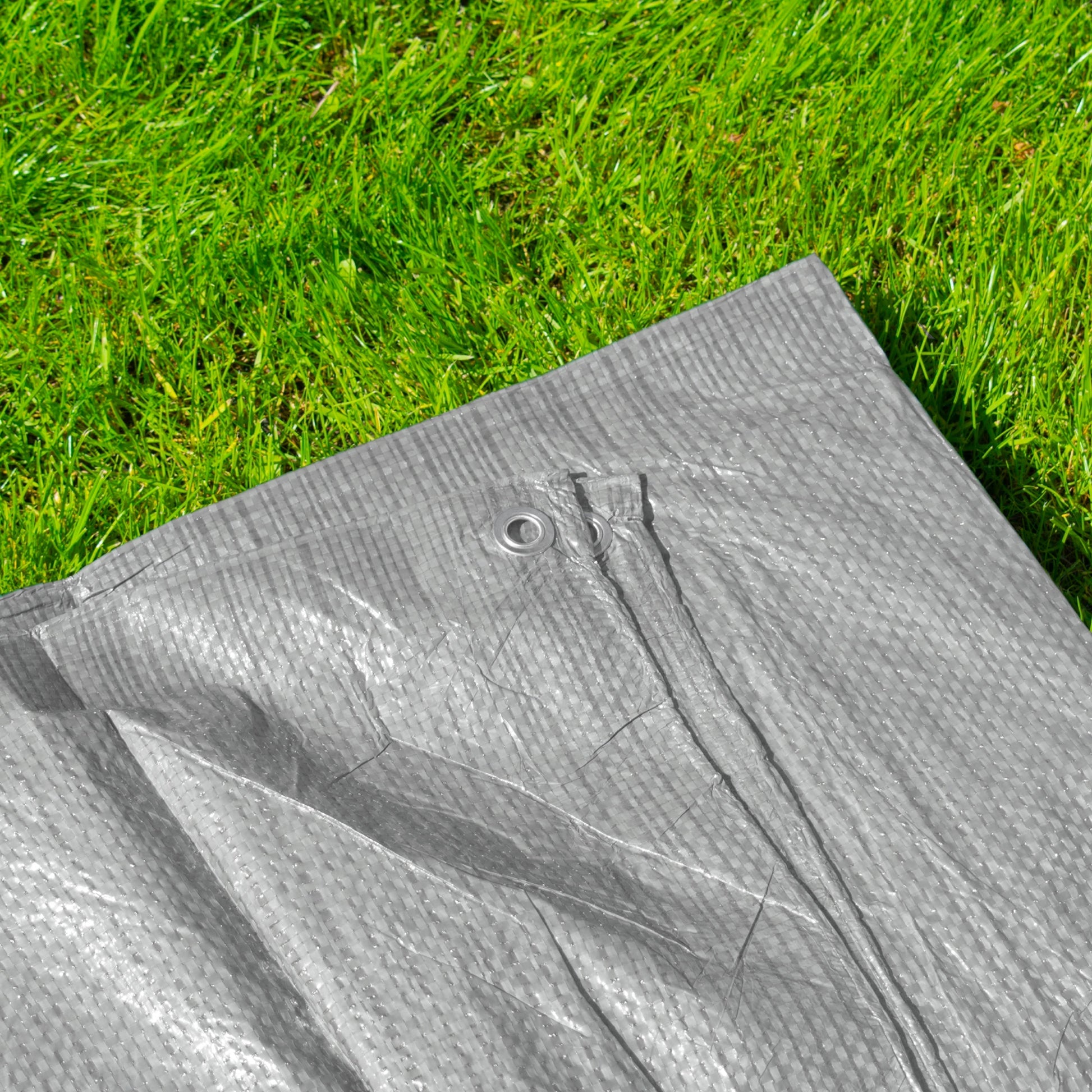 Gray tarp close-up of reinforced strip and eyelet hardware