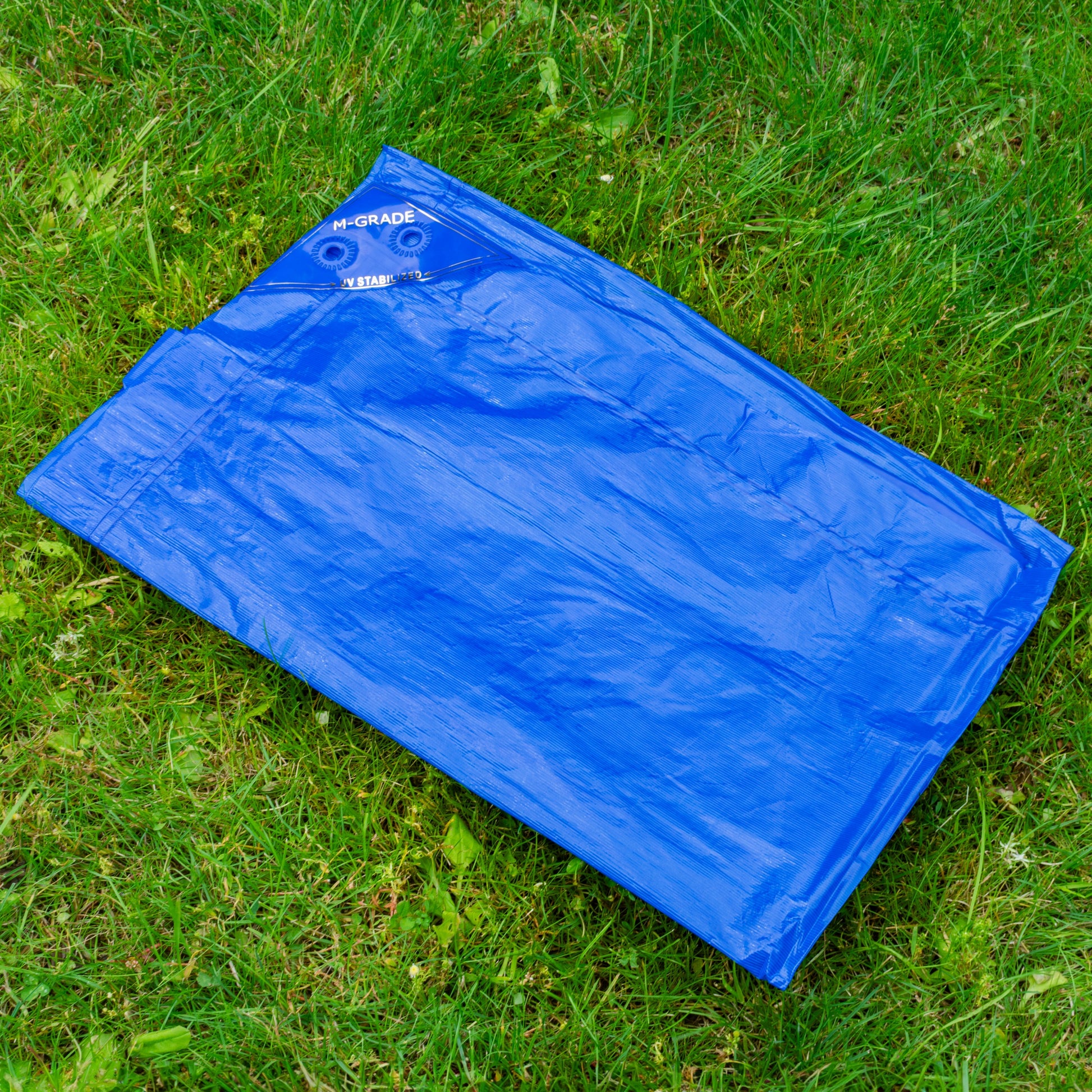 Blue LLDPE tarpaulin 1.5m x 2m laid out, M-Grade UV-stabilized markings