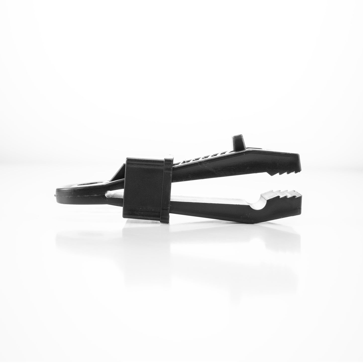 Black slide tarp clip, side view showing gripping teeth and jaw