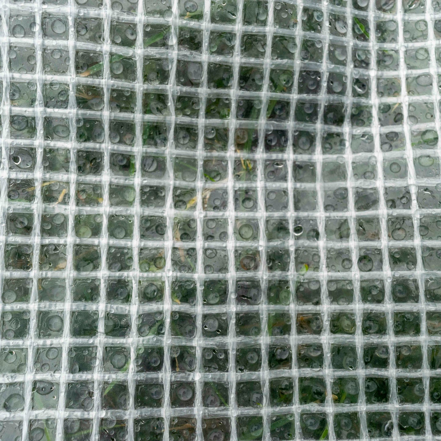 Clear tarpaulin mesh sheet with square grid weave, close-up texture