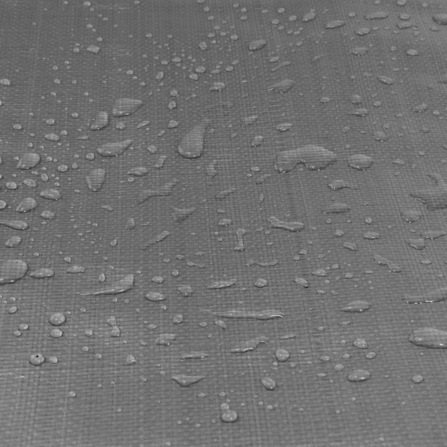 Grey tarpaulin surface close-up with water droplets on textured weave