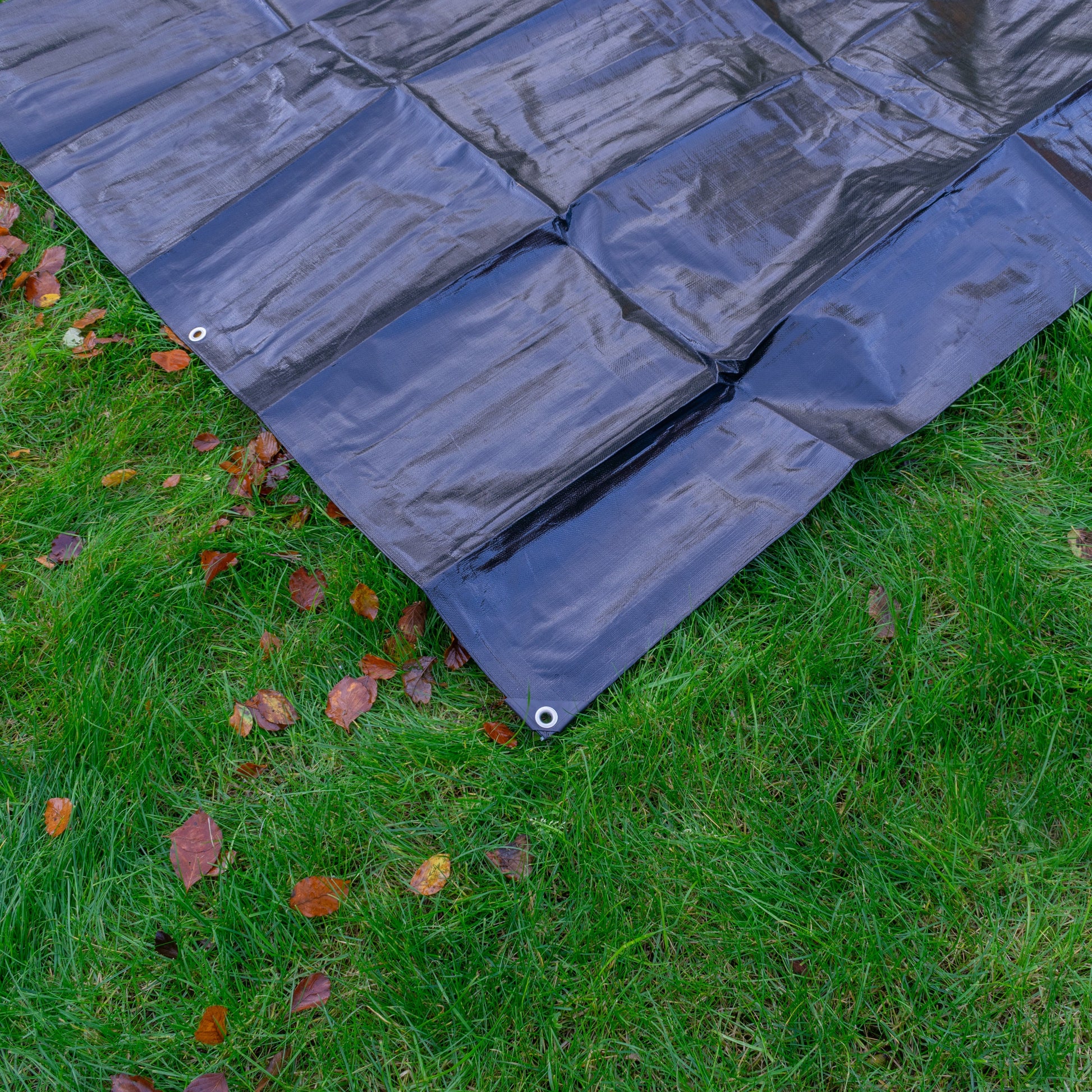 Light blue tarp with stitched panels and grommet corner