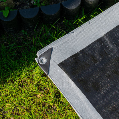Silver tarpaulin edge with metal grommet and reinforced hem stitching