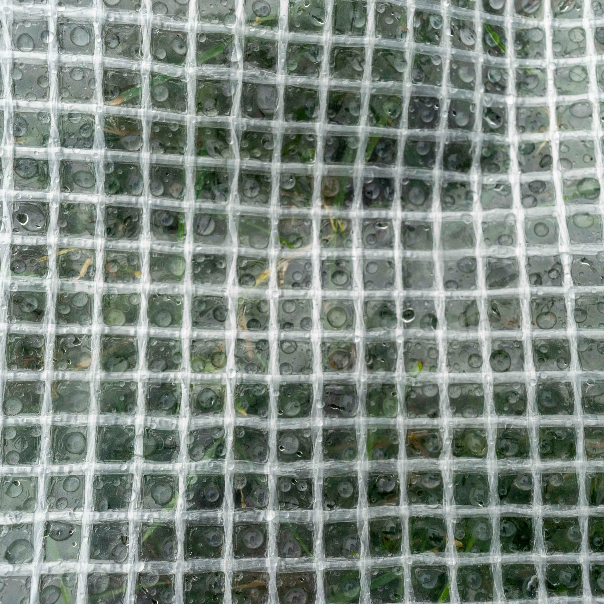 Clear XL-grade tarpaulin sheet with grid texture and water droplets