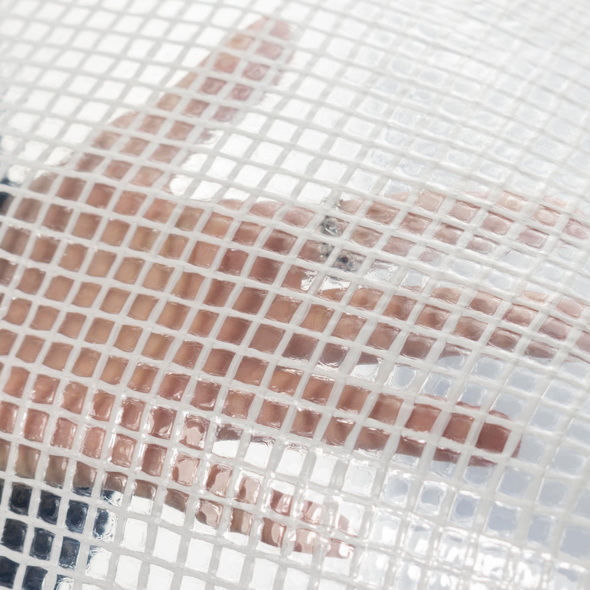 Clear XL-grade tarpaulin close-up showing grid and water beads on surface