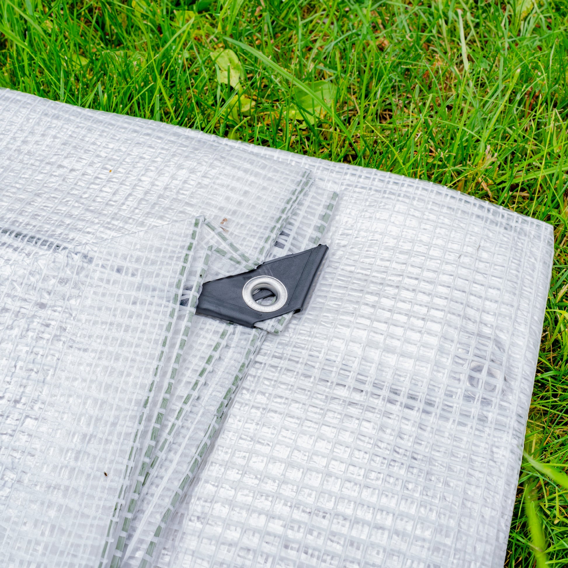 Clear tarpaulin with black grommet corner fastener, reinforced weave
