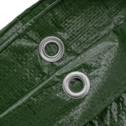 Close-up of two grommets on green tarpaulin
