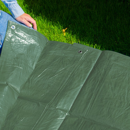 Folded green tarpaulin sheet with metal eyelets for fastening
