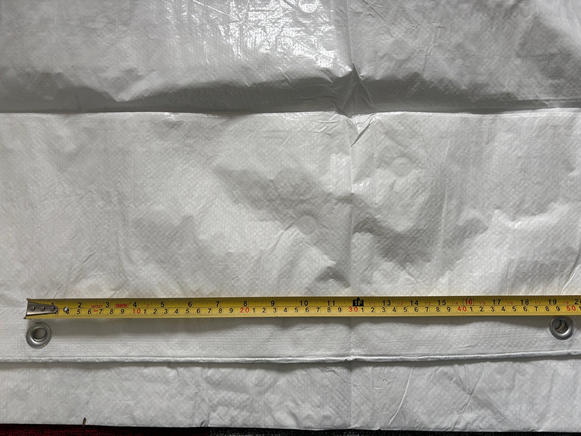White tarpaulin edge with reinforced strip and grommets, measured length