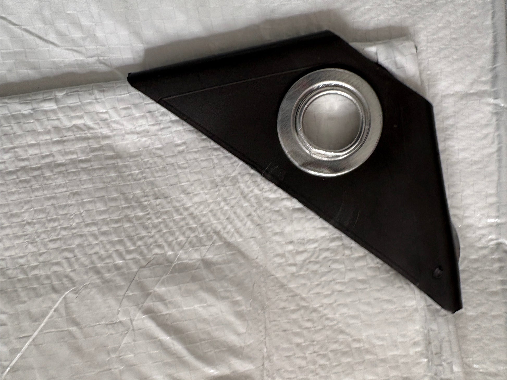 White tarpaulin with black reinforced corner and metal grommet