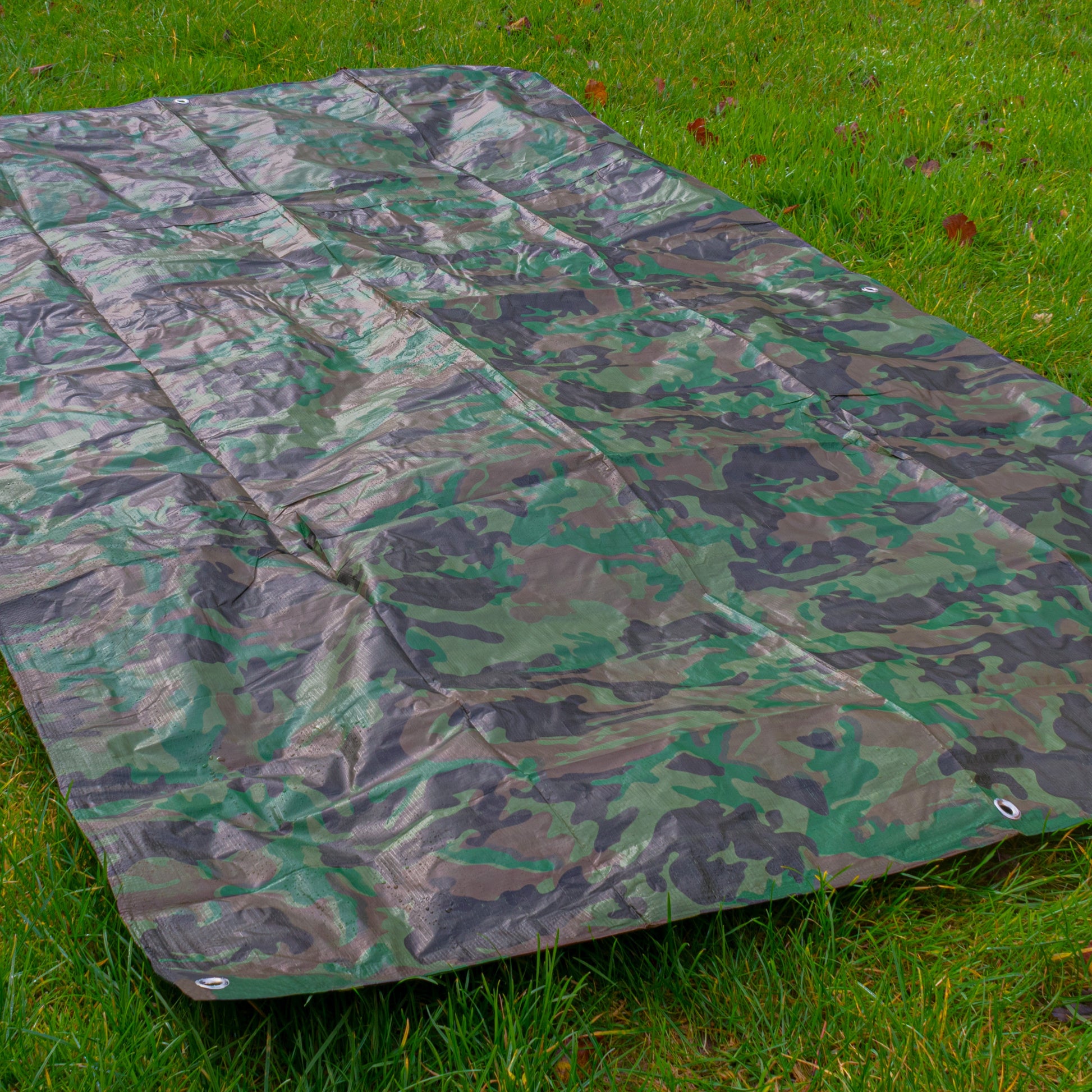 Camouflage tarpaulin 4m x 4m laid flat, ripstop texture, green/black/brown camo