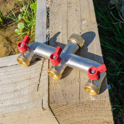Brass three-way tap splitter with three threaded 3/4" BSP ports and red shutoff knobs