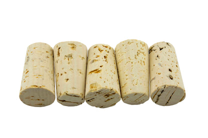 Tapered cork rolls close-up, off-white with brown marks