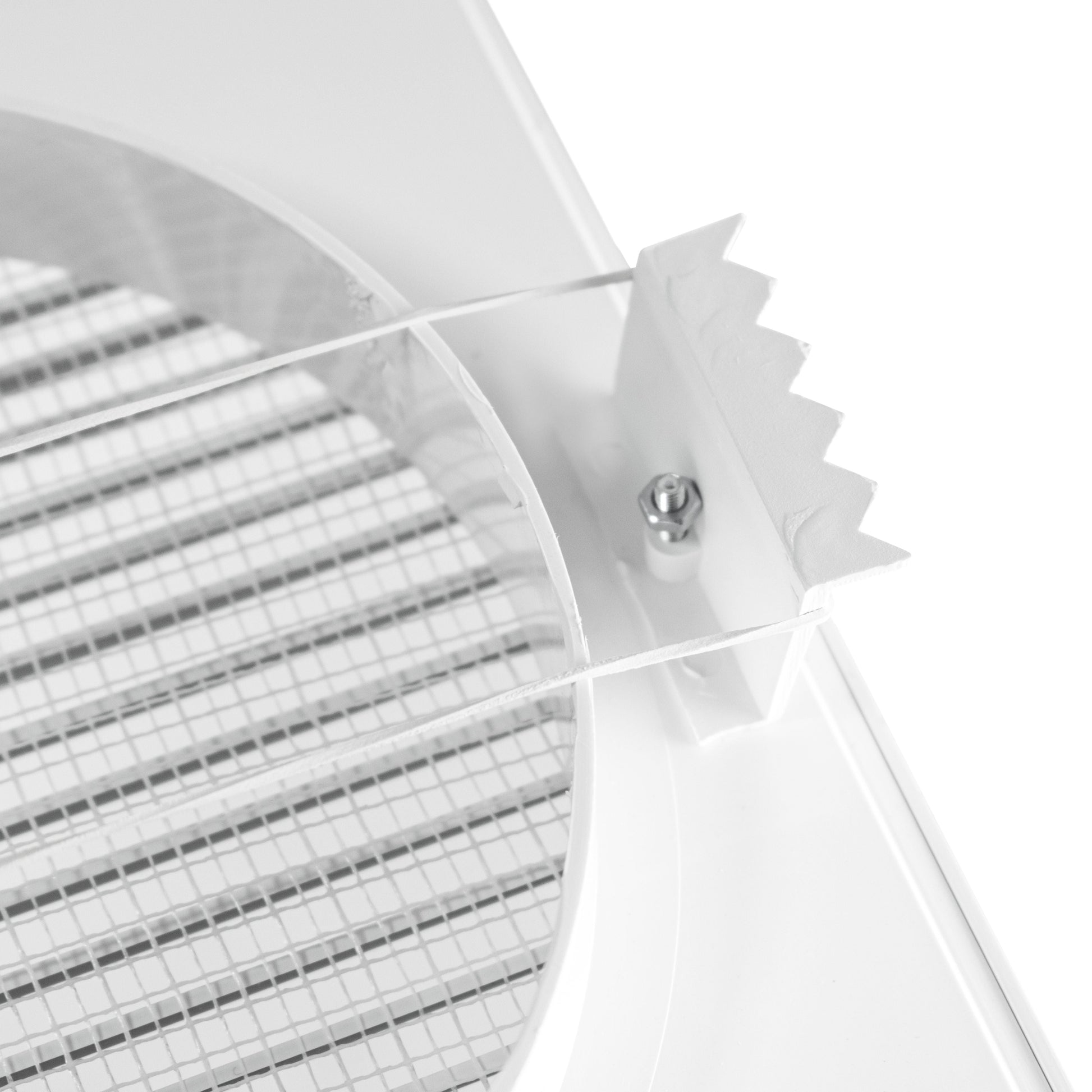Fly mesh detail near circular grille opening on white vent
