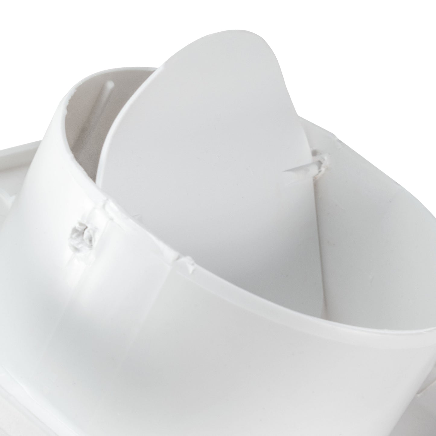Close-up of white duct connection and curved fan outlet housing