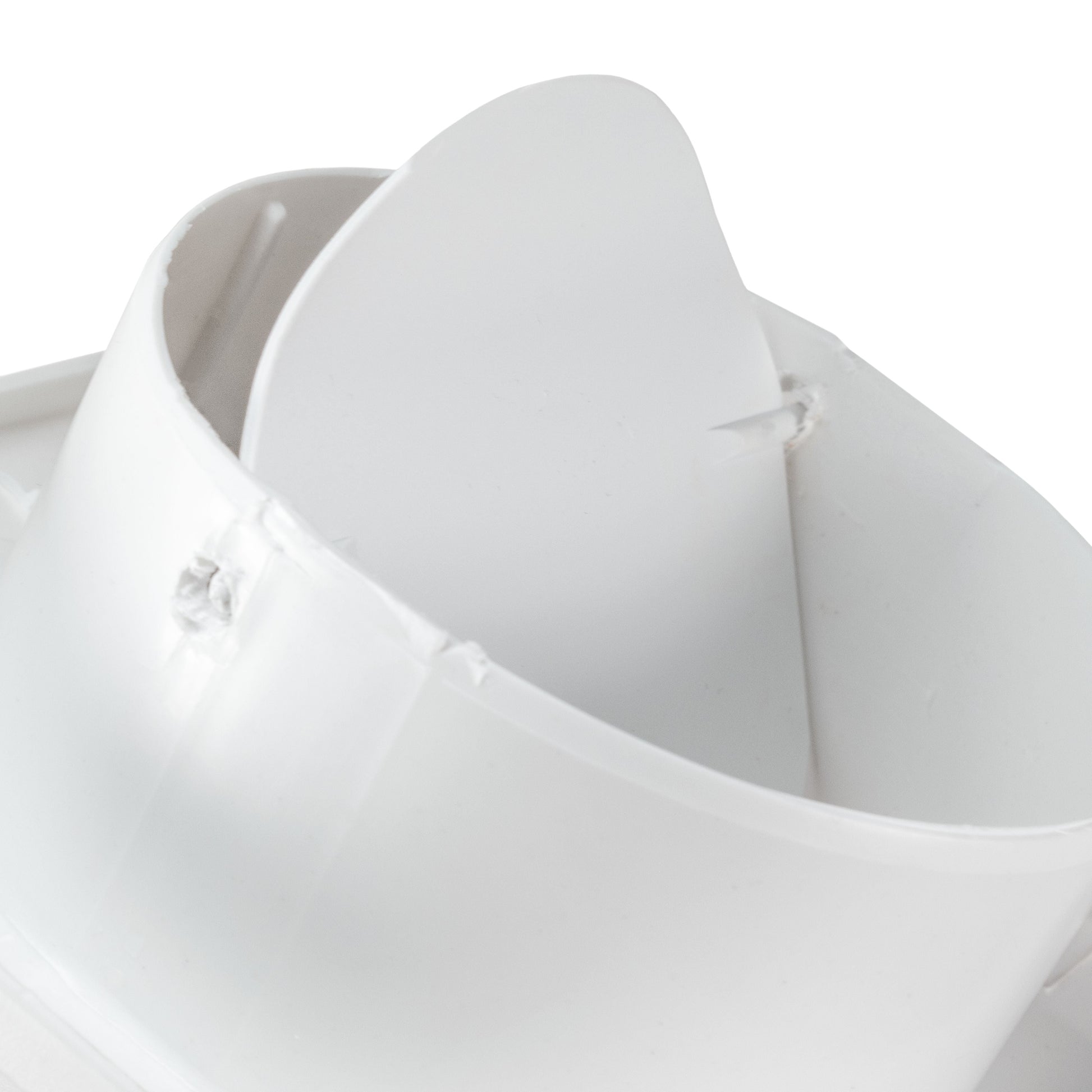 Close-up of white duct connection and curved fan outlet housing