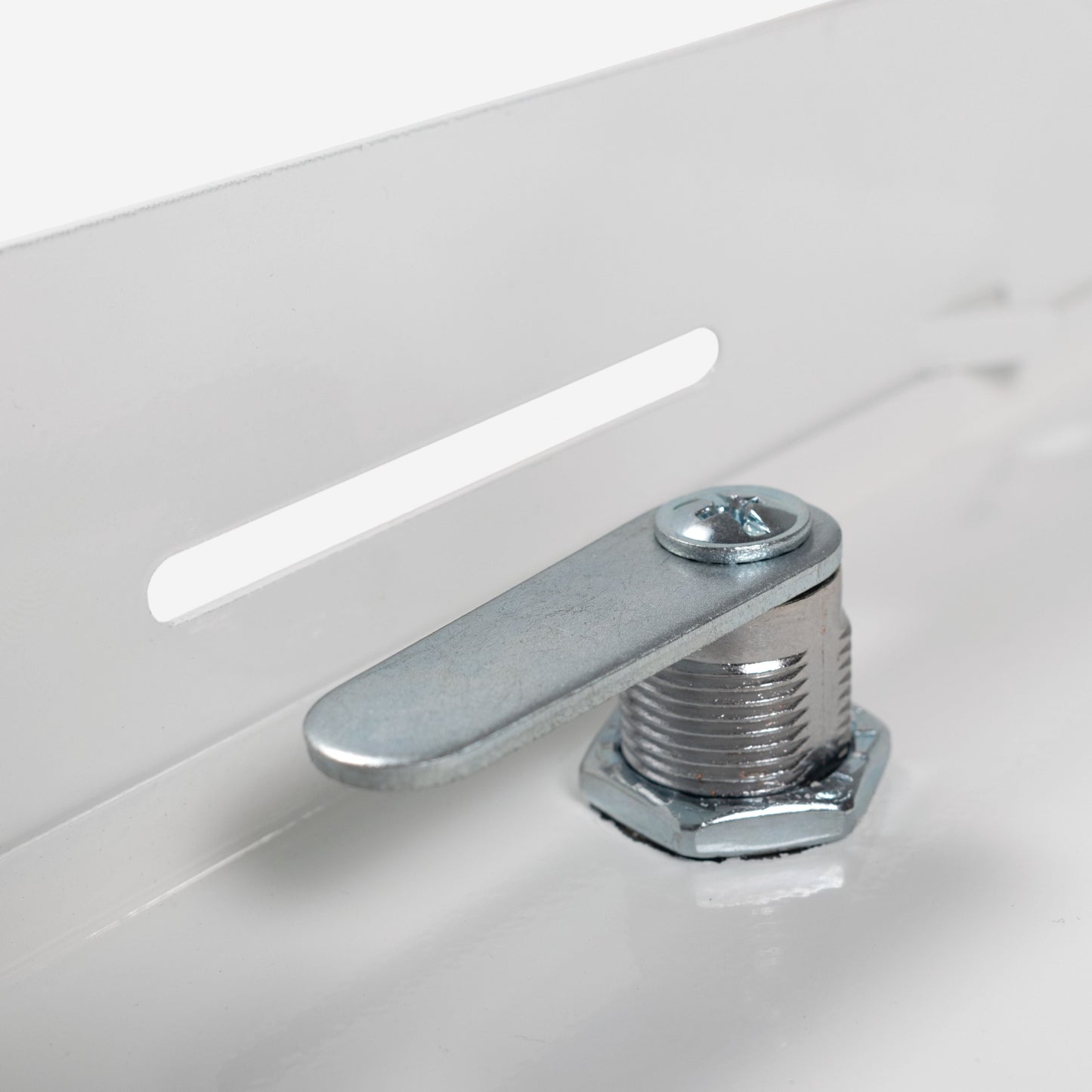 Close-up of white access panel lock bolt and mounting hardware