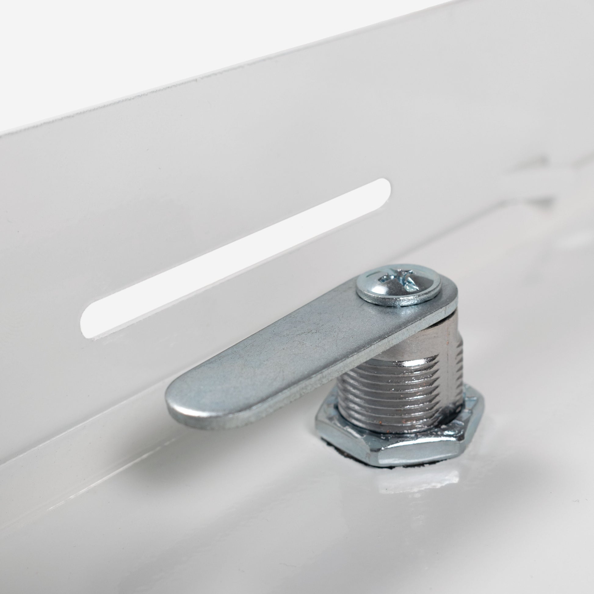Close-up of white access panel lock bolt and mounting hardware