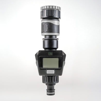 Gray water flow meter with LCD screen, silver ribbed top, and bottom hose connector