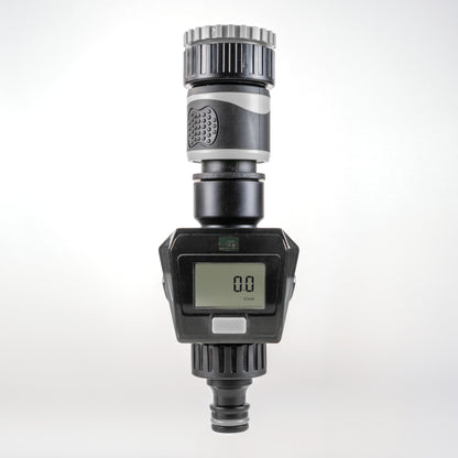 Gray water flow meter close-up showing LCD digits and gray plastic housing