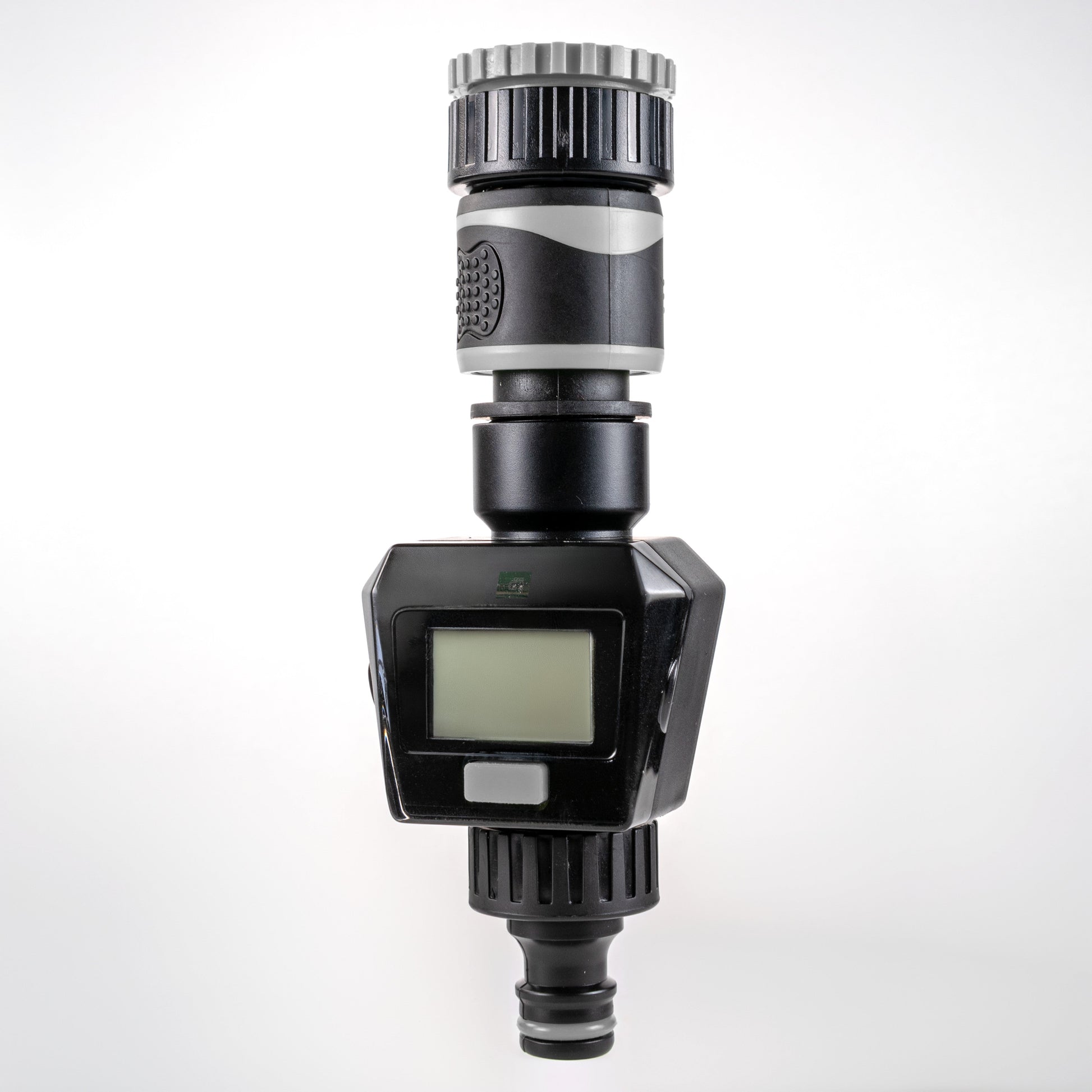 Gray water flow meter front view with LCD display and ribbed top fitting