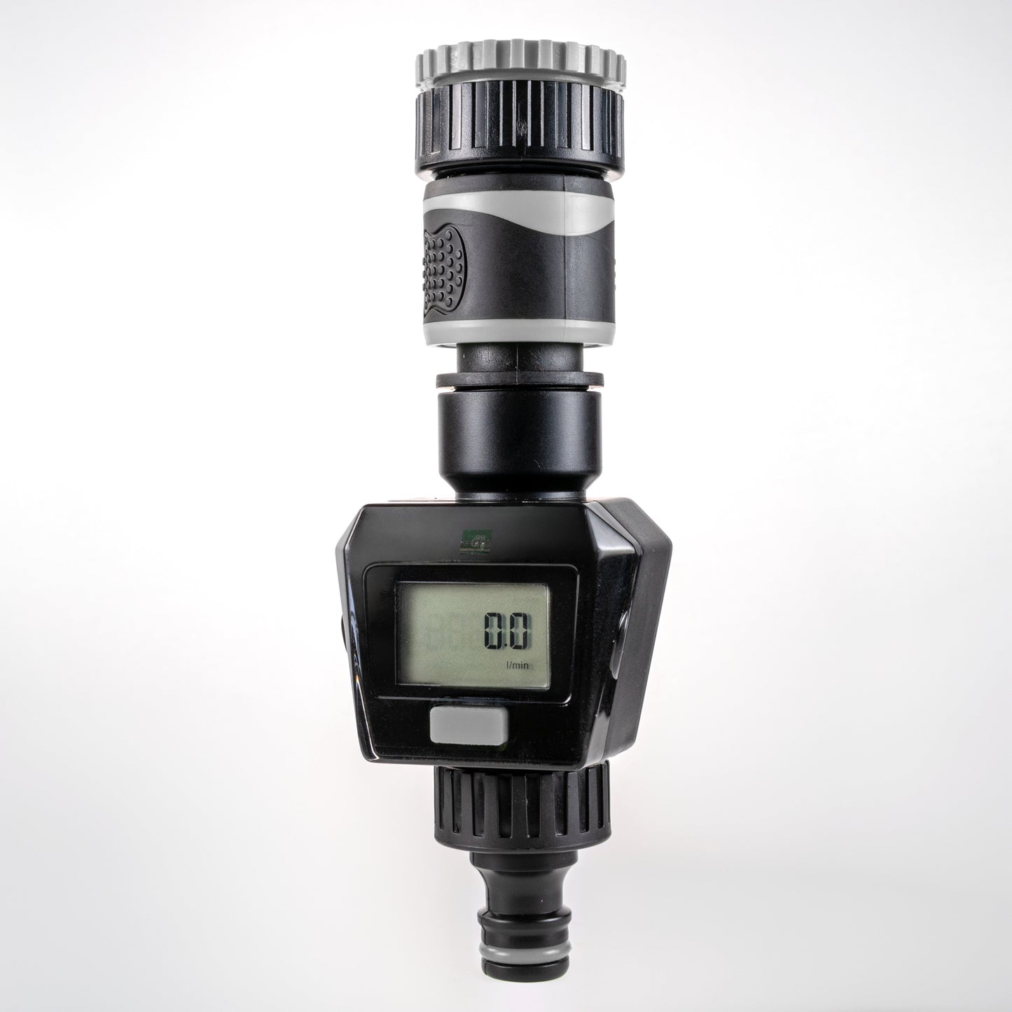 Gray water flow meter with LCD display, silver ribbed top, and inlet/outlet connectors