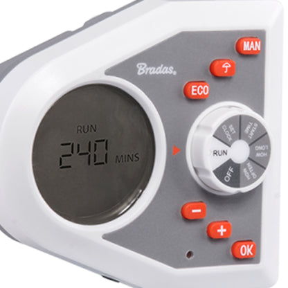 Close-up: white electronic water timer face with RUN minutes display and orange buttons
