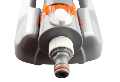 Close-up of sprinkler water outlet with white knob and orange collar