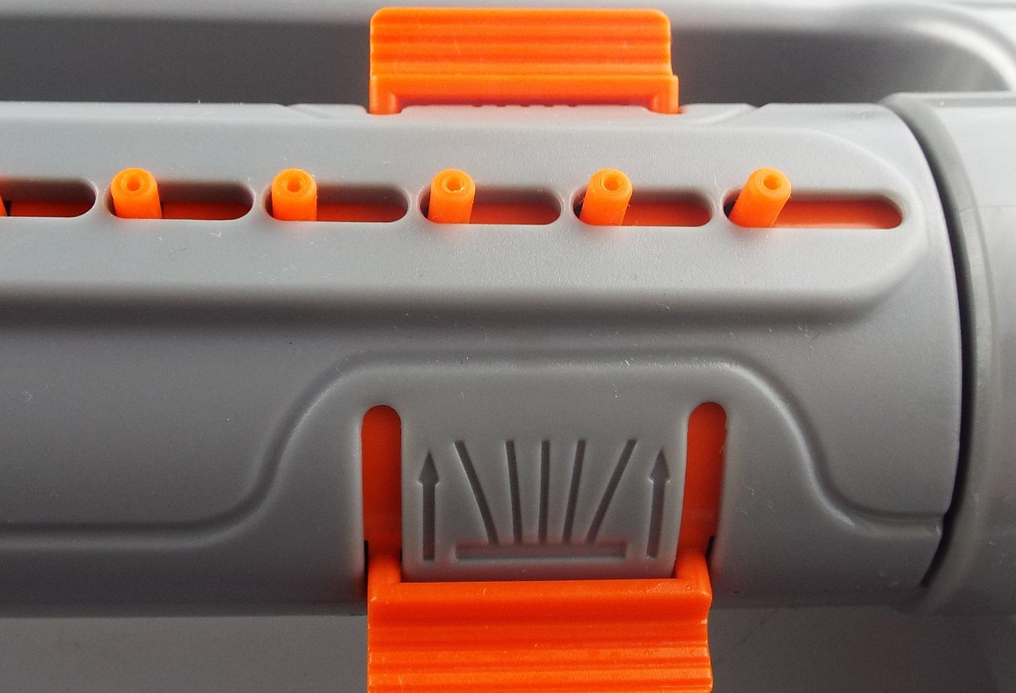 Sprinkler spray pattern adjustment section with orange lever and ridged gray insert