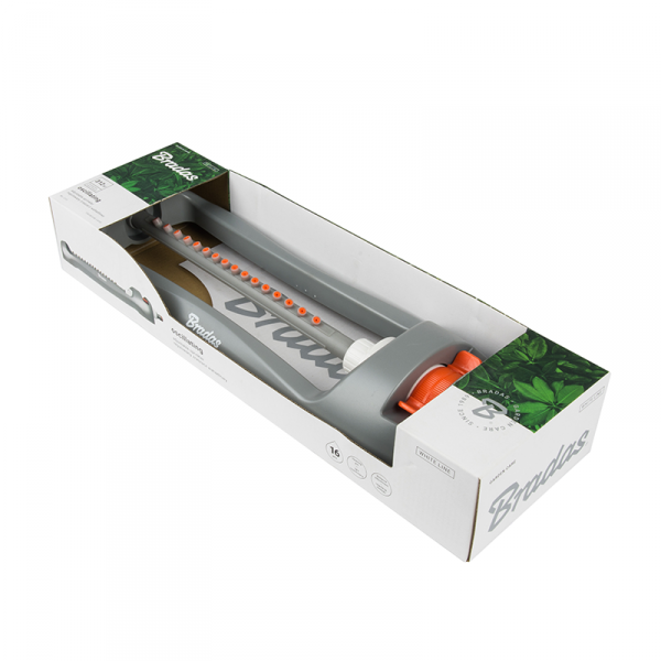 Sprinkler in retail box packaging, gray body with orange control dial visible